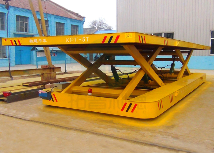 Towed cable powered bay to bay material motorized transfer bogie